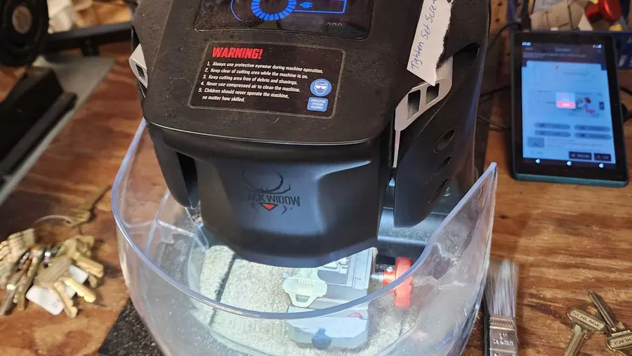 Key cutting machine with fresh-cut keys on the St. Clair & Lee's Locksmith Plus workbench